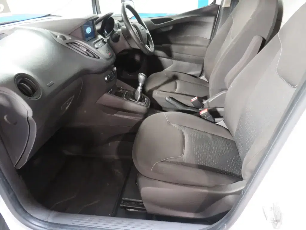 White Ford Transit Courier.