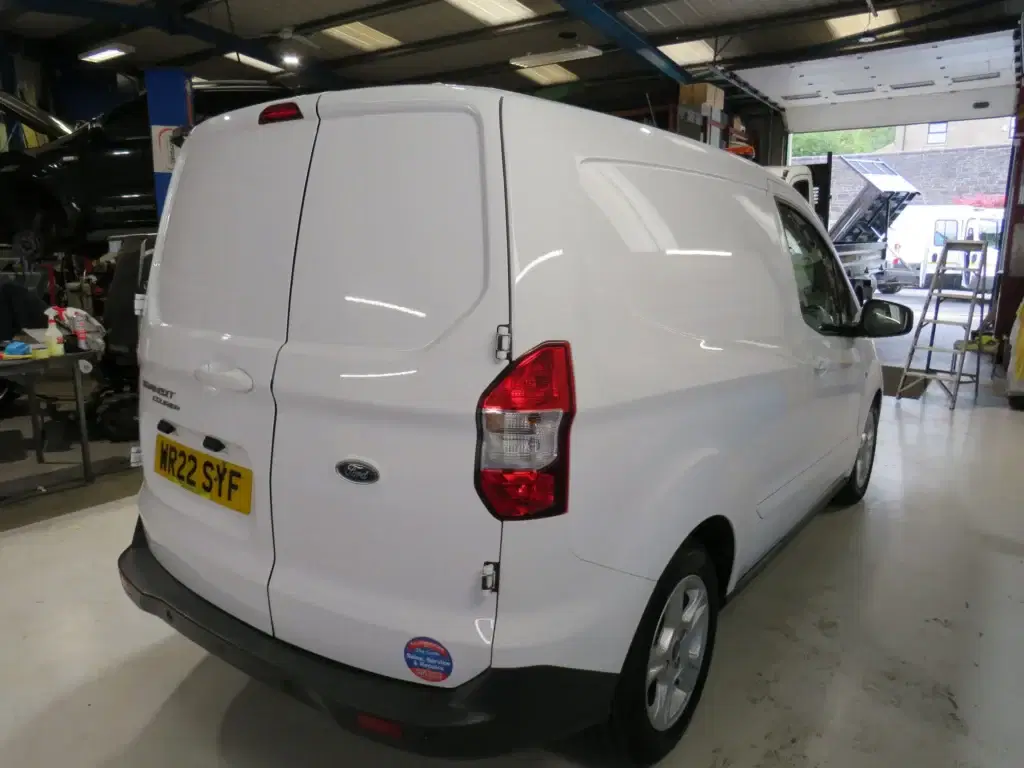 White Ford Transit Courier.