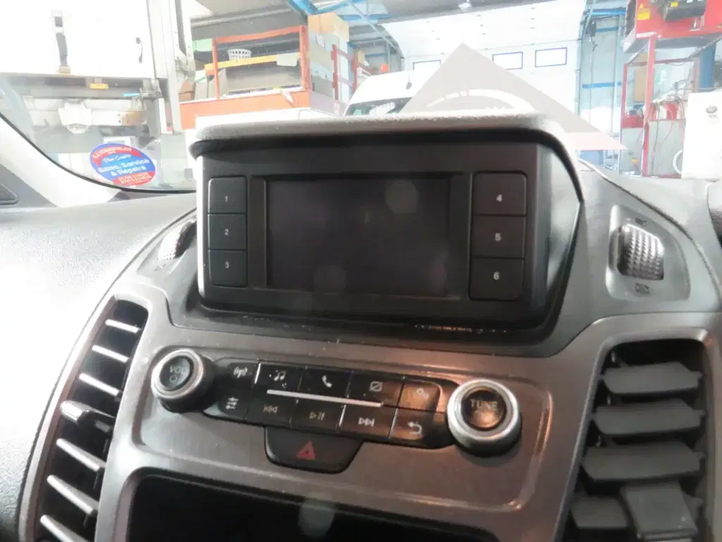 White Ford Transit Connect.