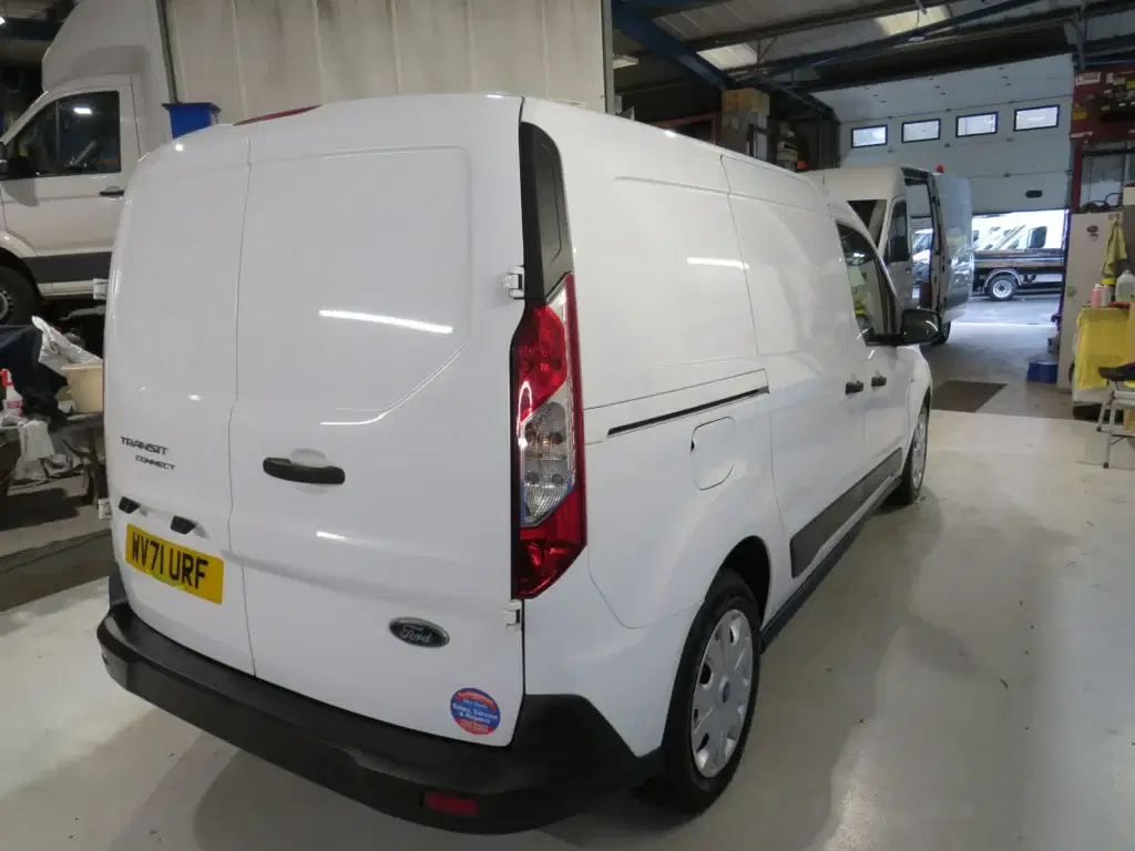 White Ford Transit Connect.