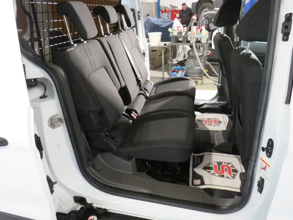 White Ford Transit Connect.