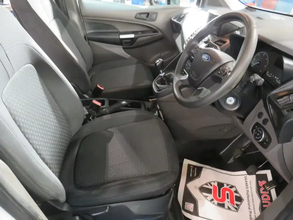 White Ford Transit Connect.