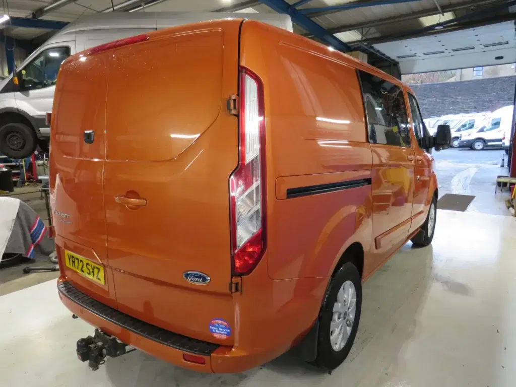 Orange golden Ford Transit Custom.